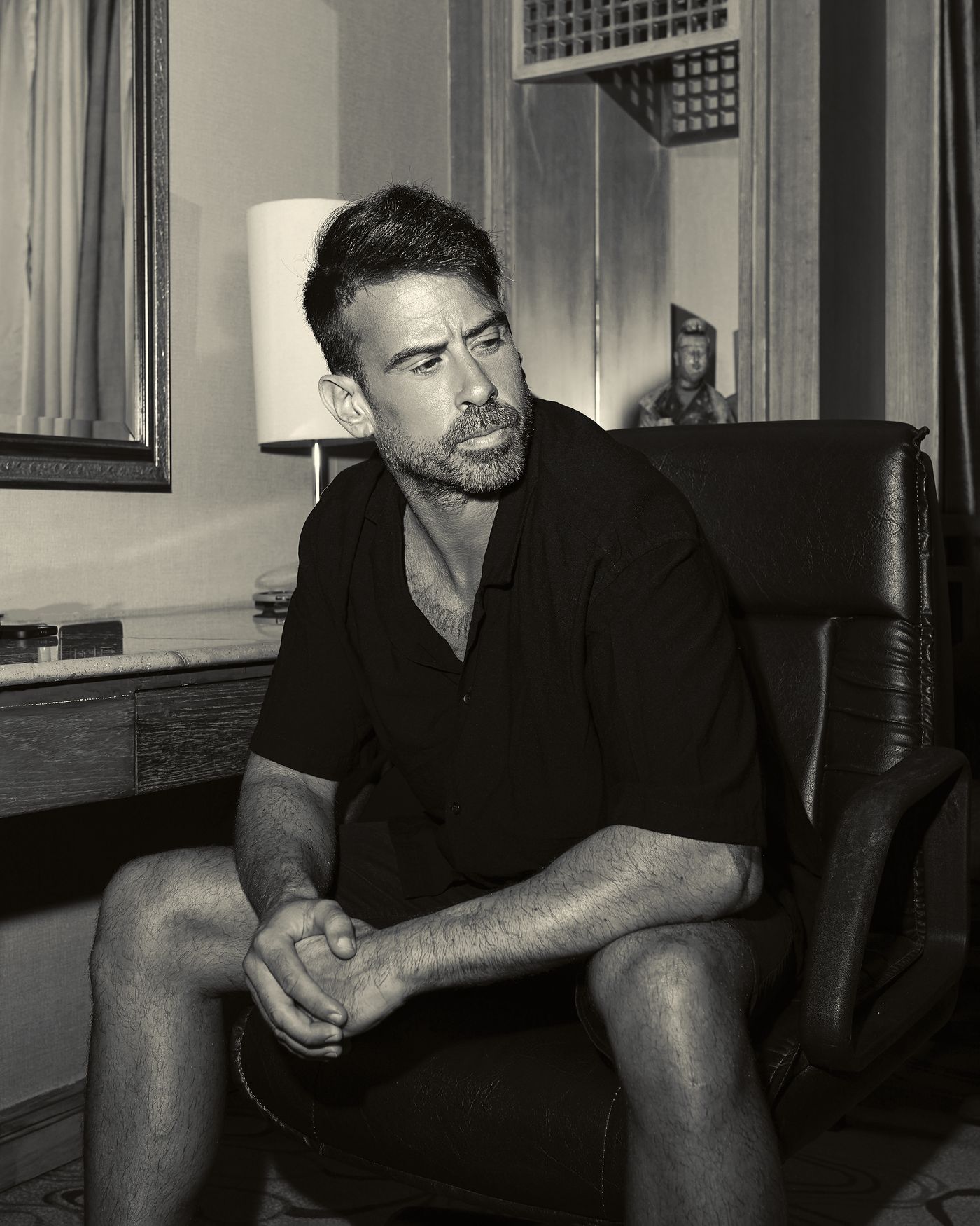 ARACIL seated in an armchair, black and white press photo